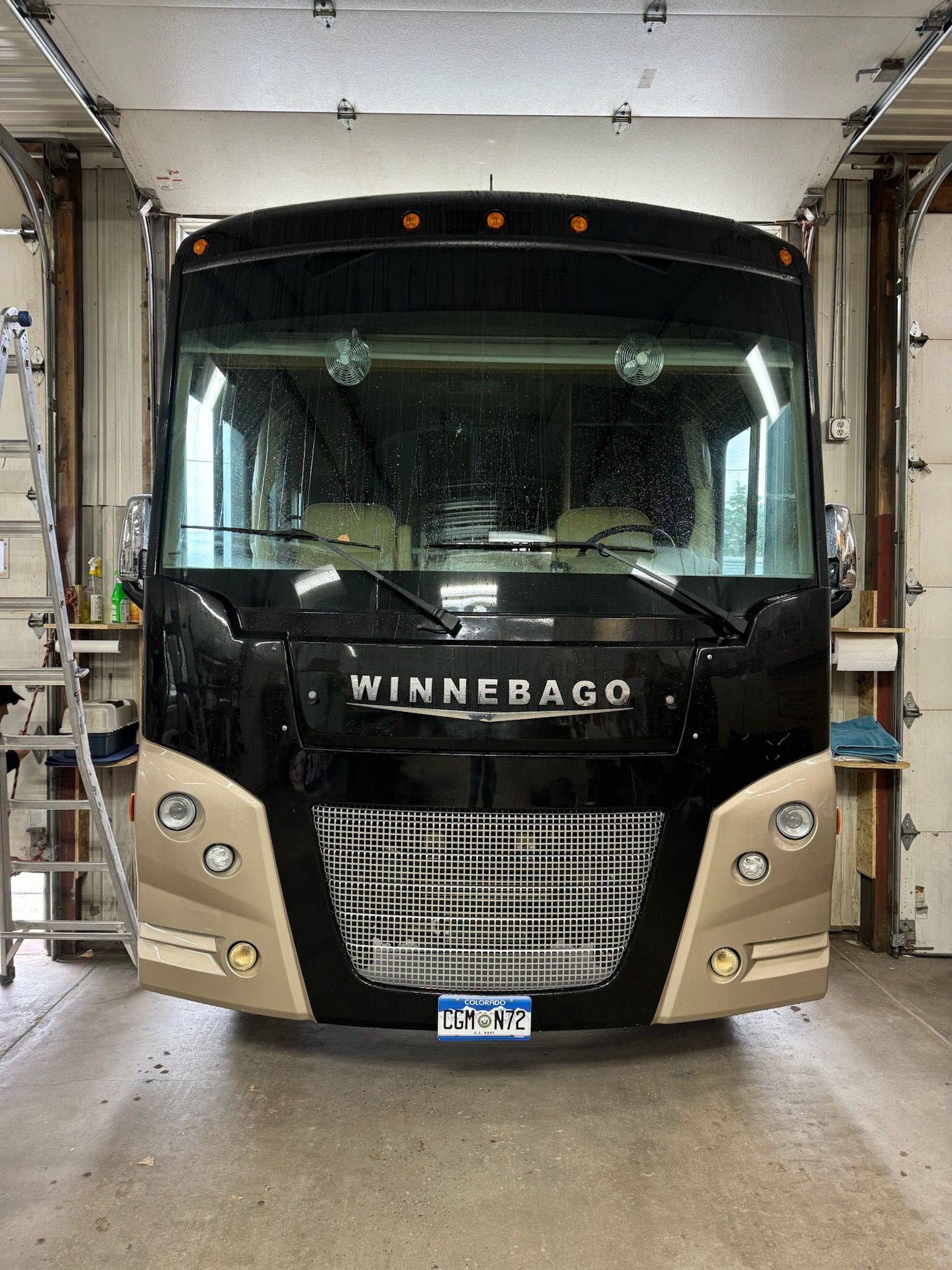 A winnebago rv is parked in a garage