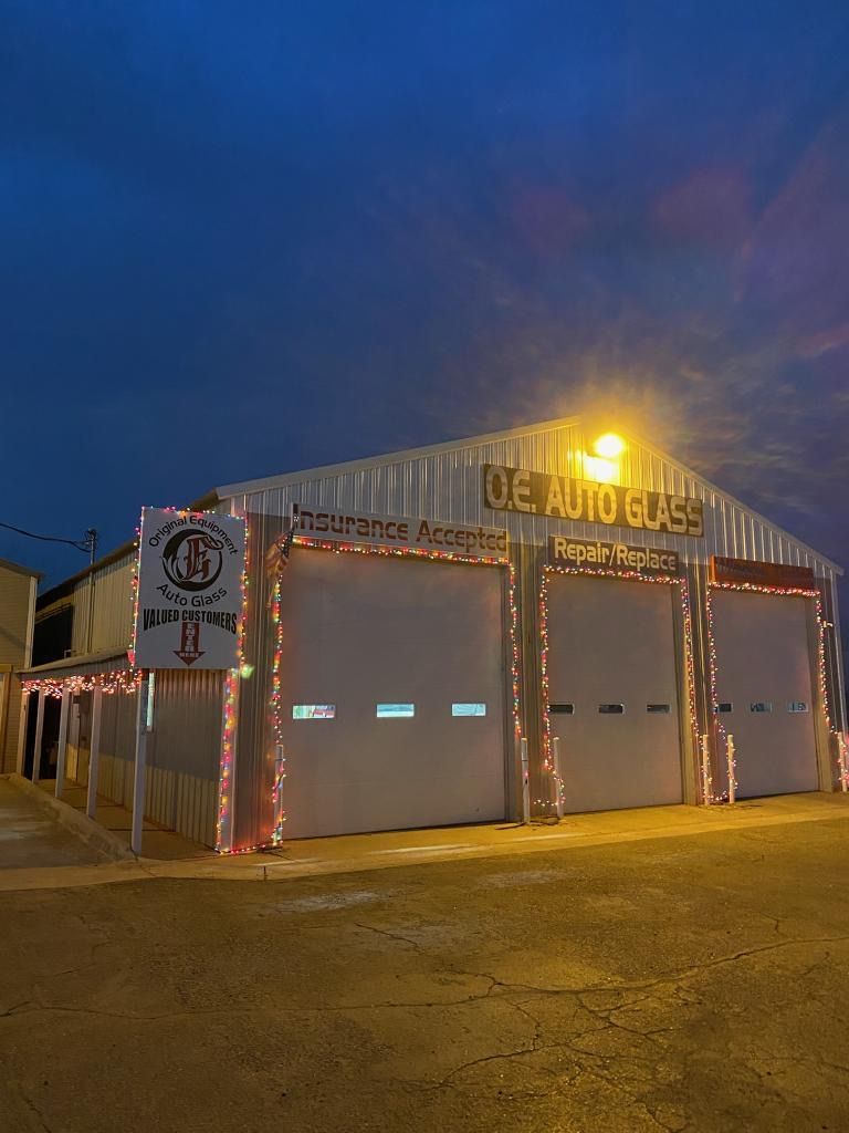 A garage is decorated with christmas lights at night.