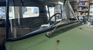A close up of a car windshield in a garage.