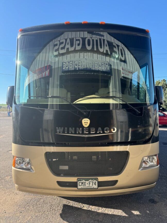 A winnebago bus is parked in a parking lot.