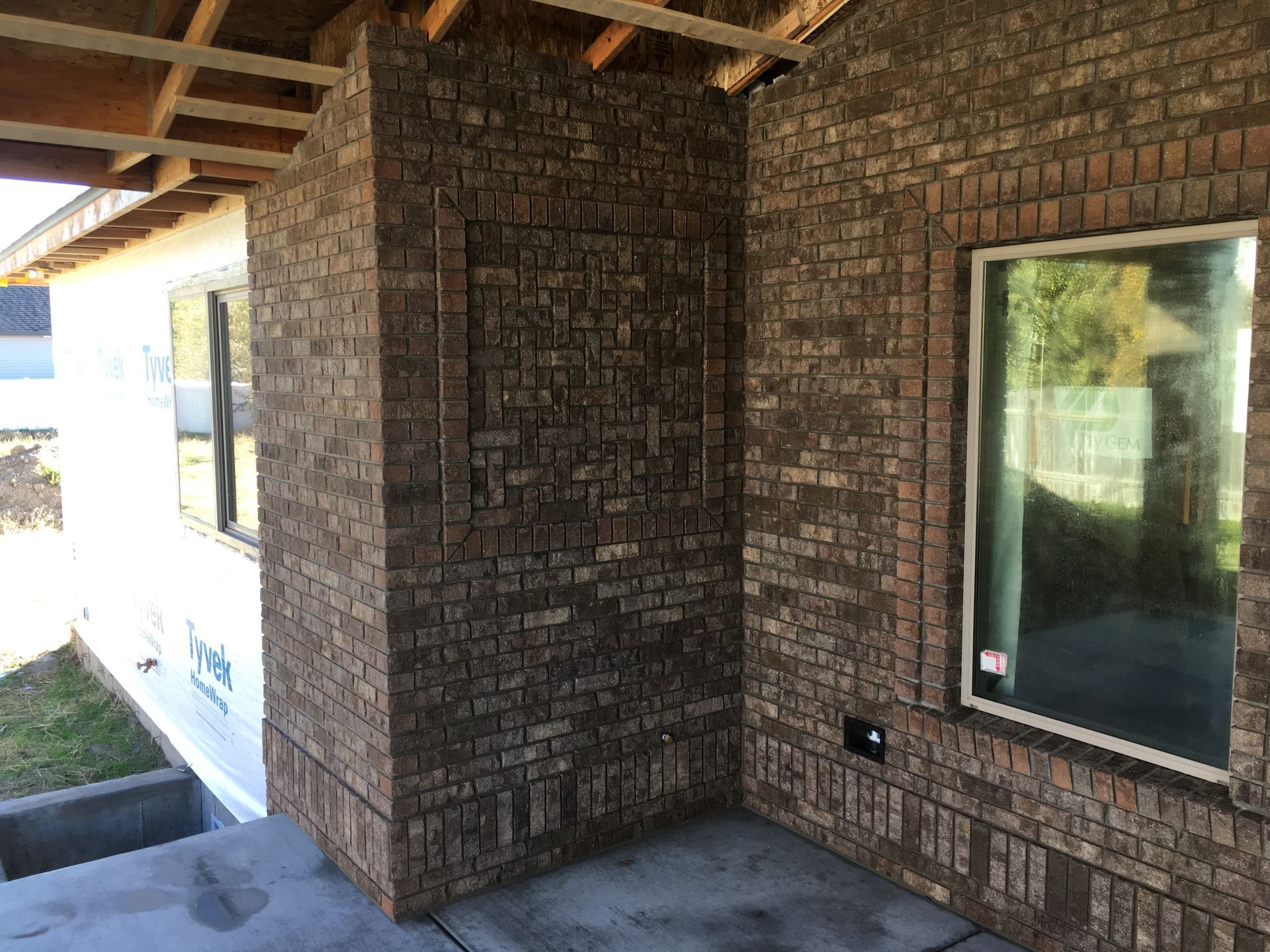 A brick wall with a window on the side of a house