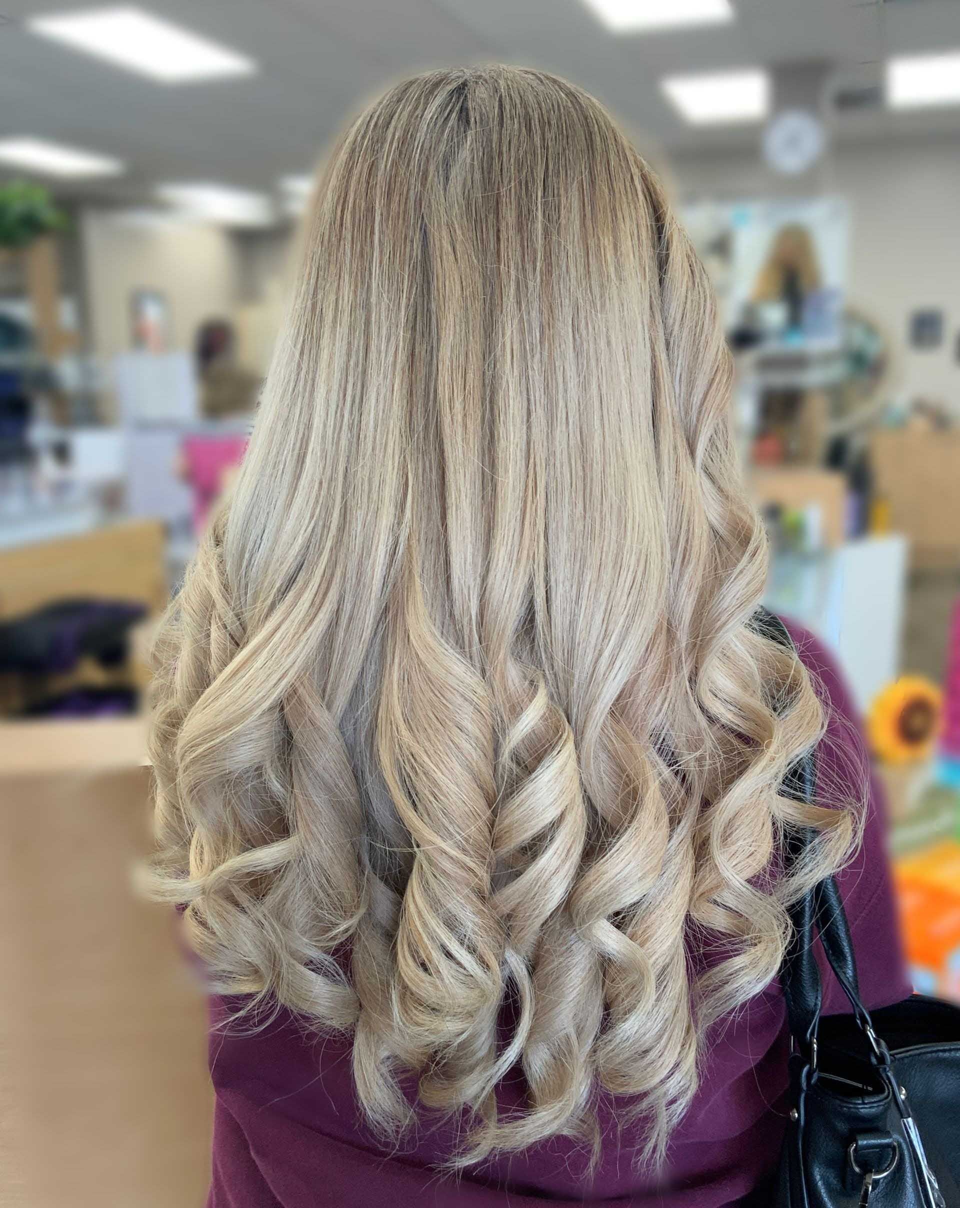 Long, light blonde crimped hair with large, bouncy curls, viewed from the back.