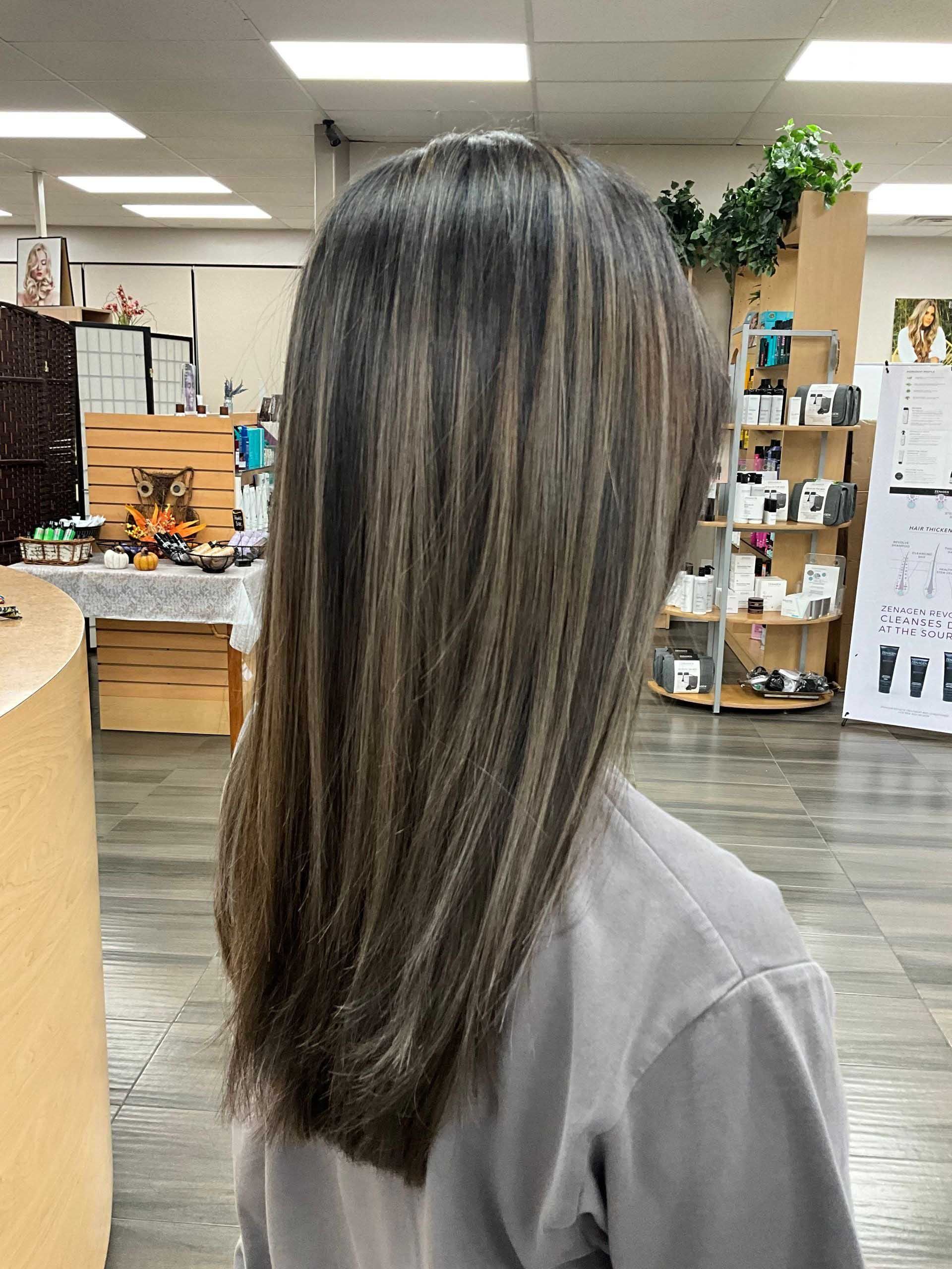 Person with long hair, highlighting color contrast, inside a store.