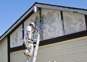 A man climbing a roof using a ladder