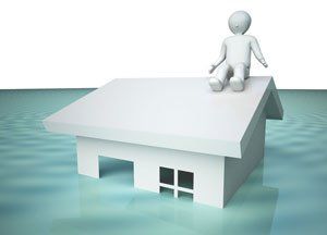 An illustration of a house flooded with water with a man on top of the roof