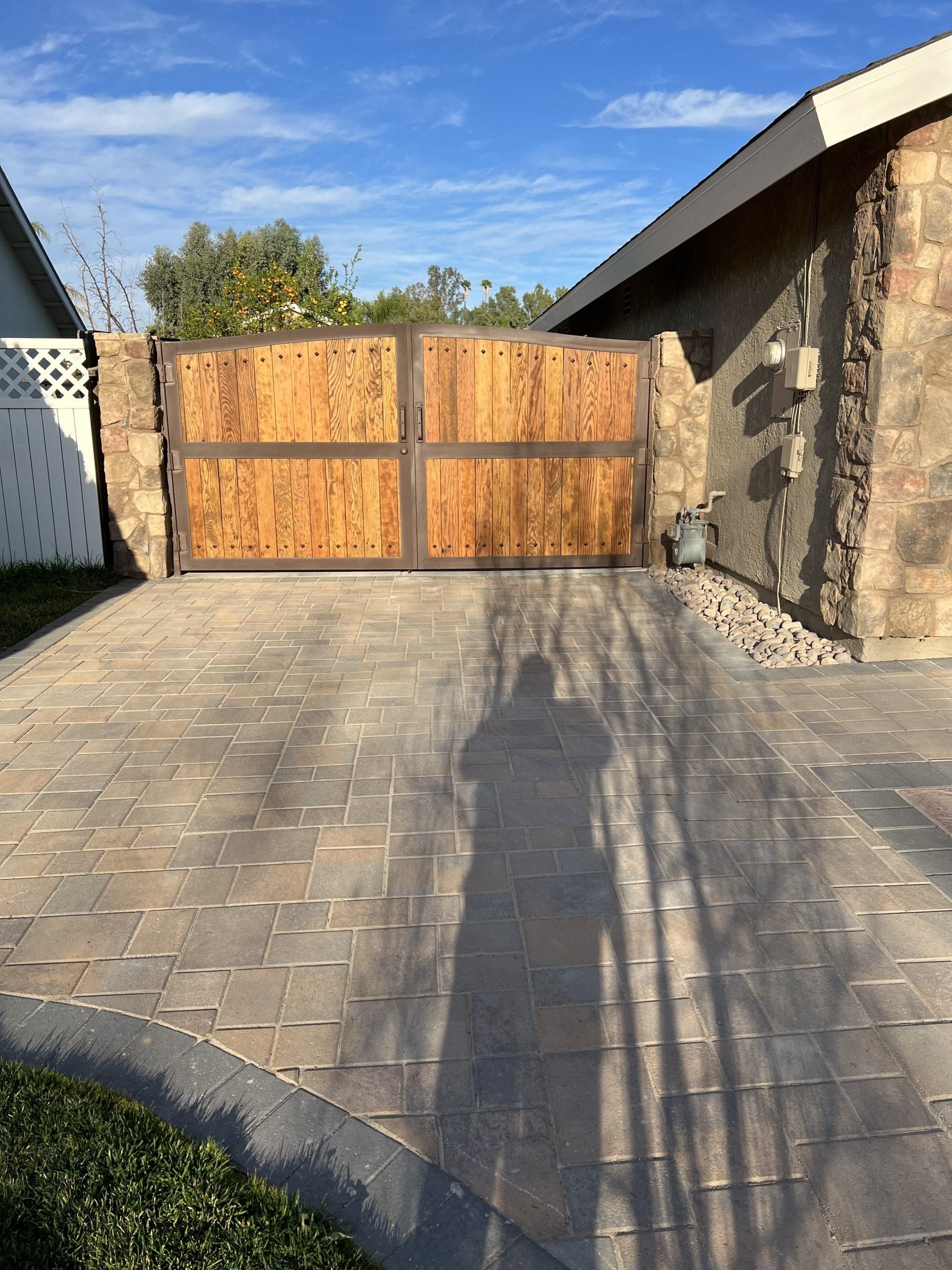 multi colored bricks entry and wooden gate