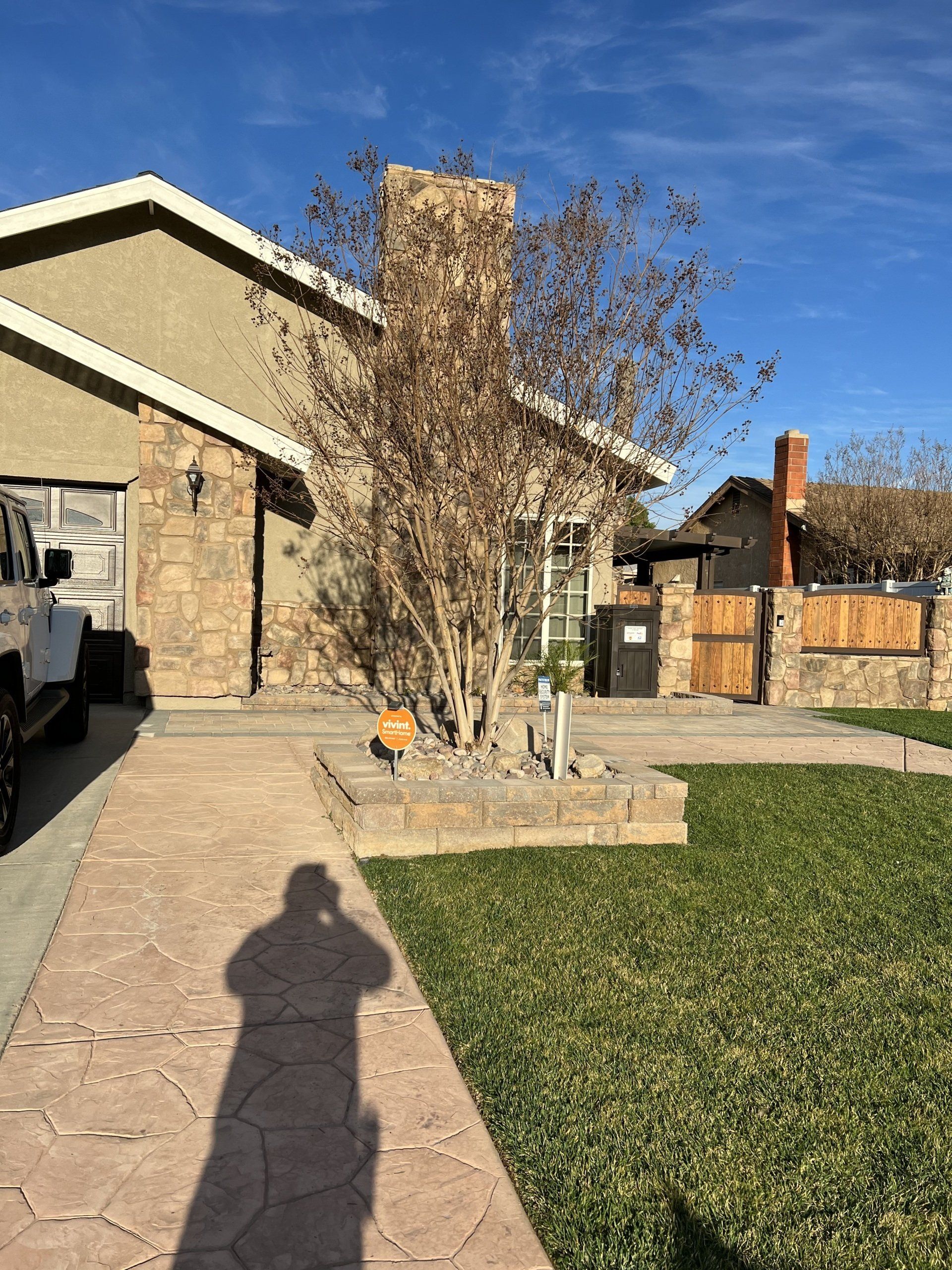 house front view with parked white car