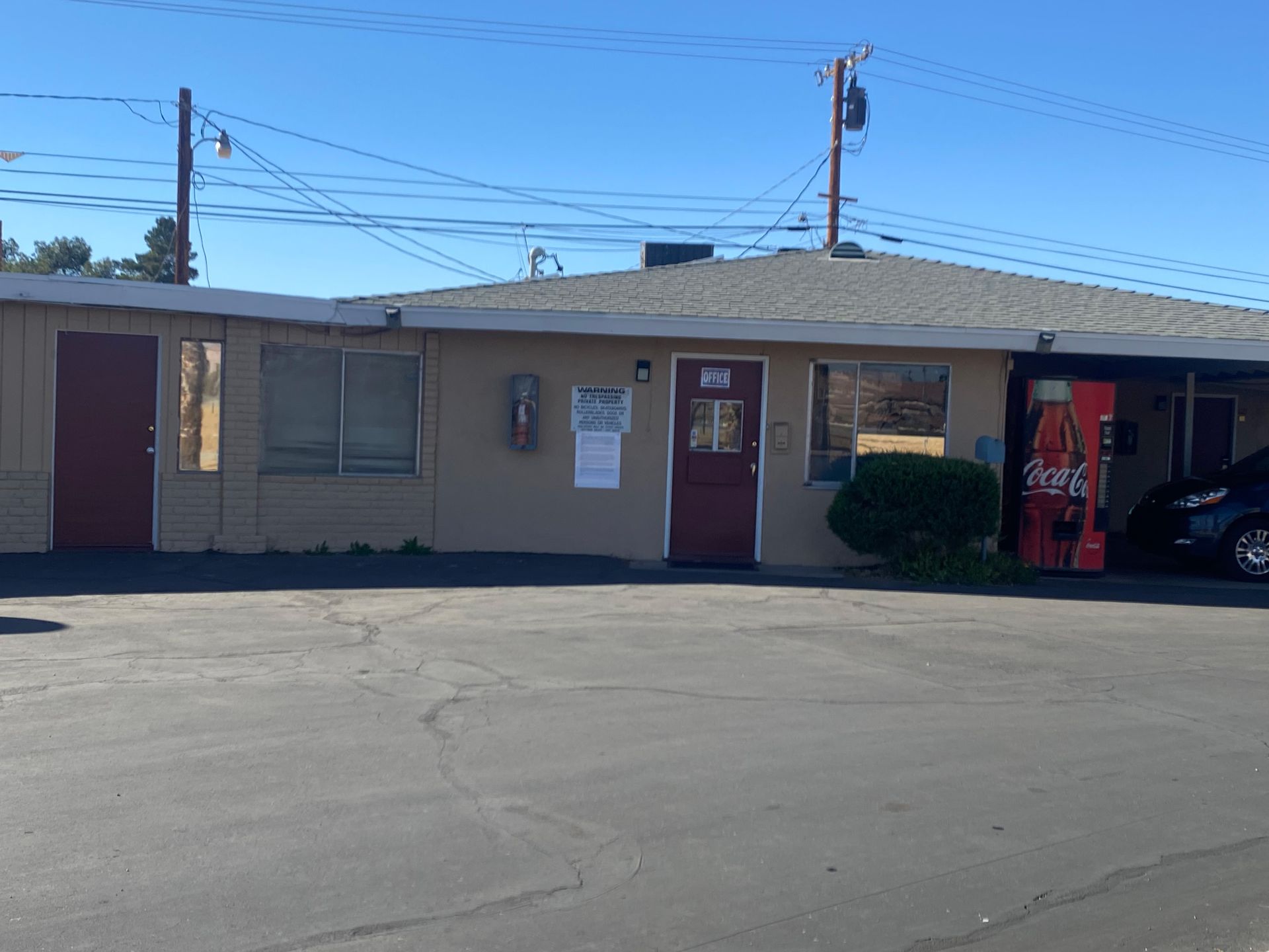 A building with a coca cola vending machine in front of it