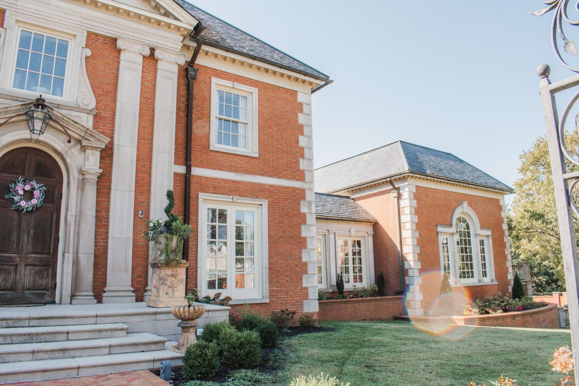 A large brick house with a wreath on the front door.