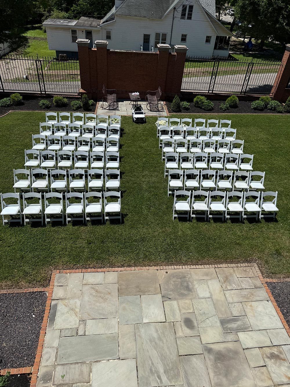 A bunch of white chairs are lined up in a row