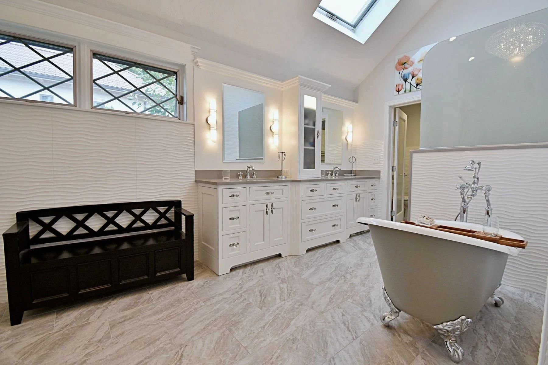 Bathroom with white cabinets, a clawfoot tub, and a decorative window.