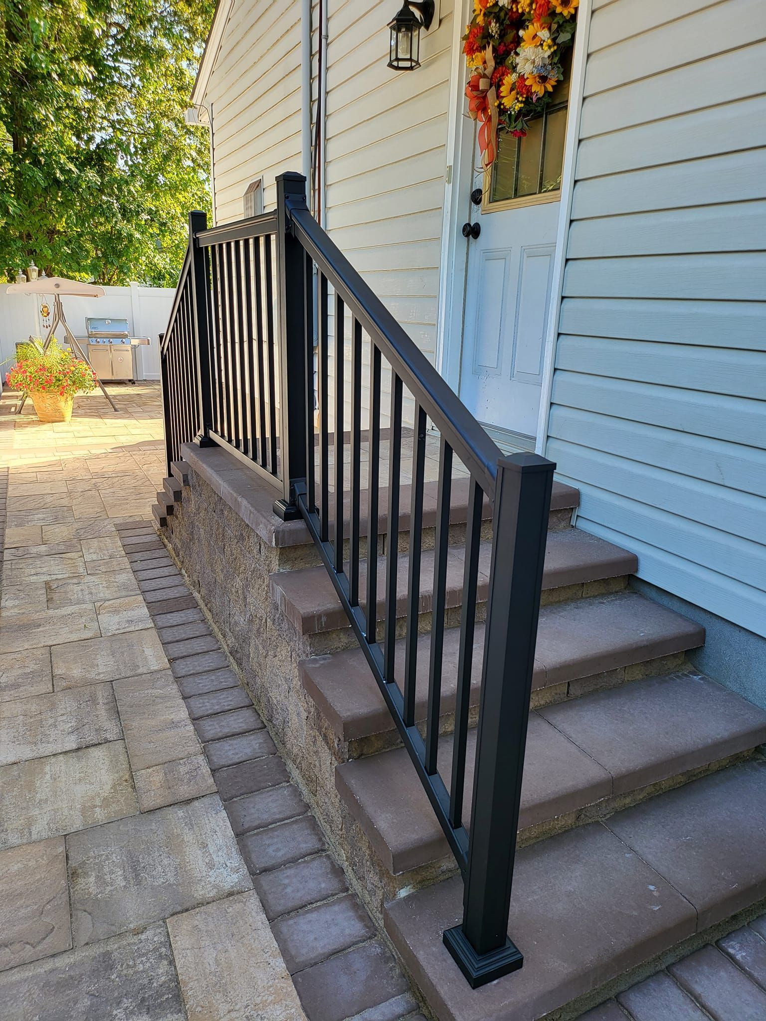Front steps with black handrail 