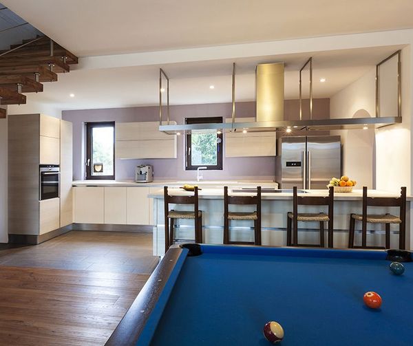 A pool table in the middle of a kitchen