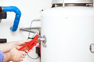 Plumber fixing an hot-water heater