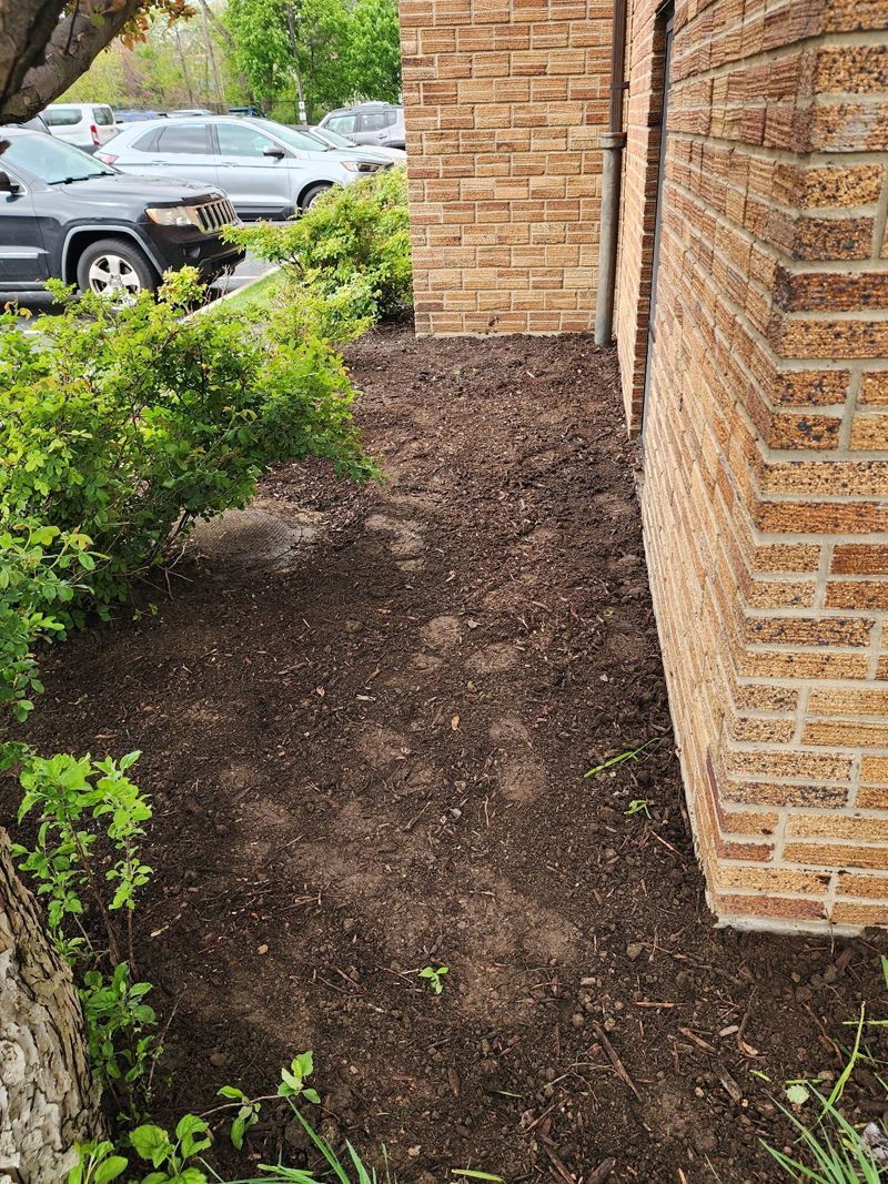 A brick building with a lot of dirt in front of it.