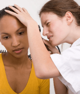 Doctor looking at a patient's ear