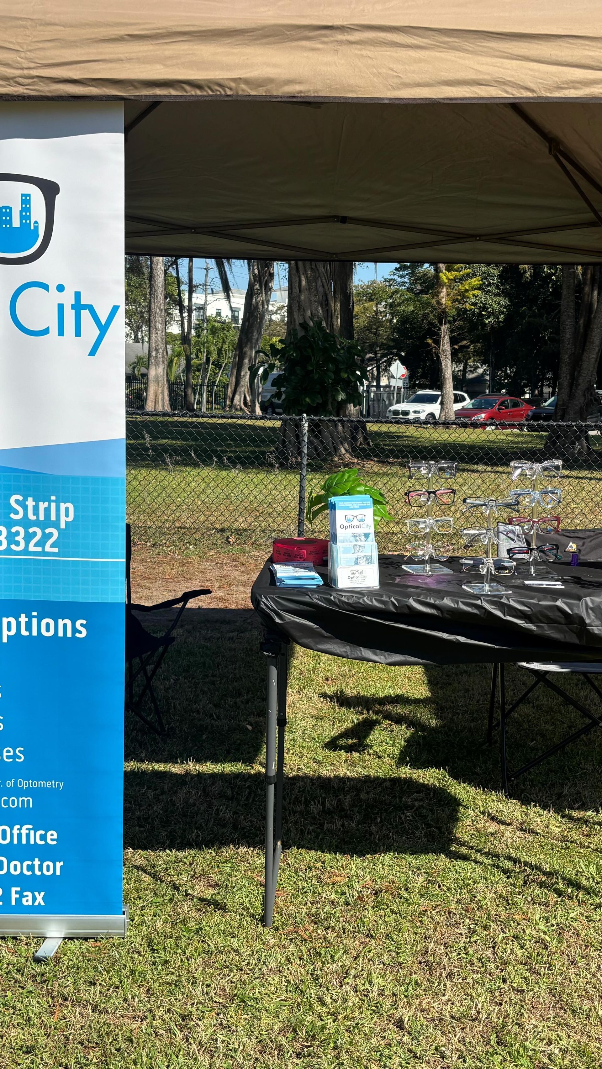 A blue banner is hanging from a tent next to a table.