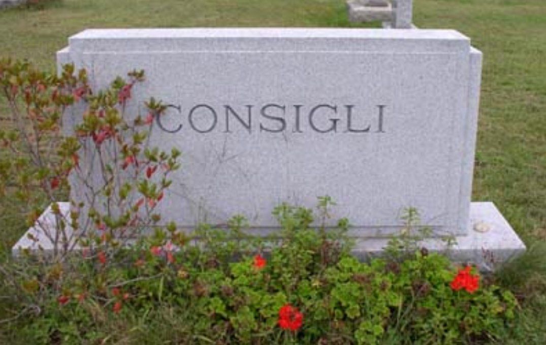 A gravestone in a cemetery with the name consigli written on it