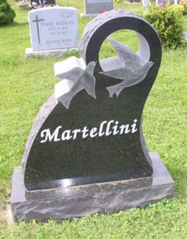 A gravestone for bellerose with a statue of a woman holding a baby