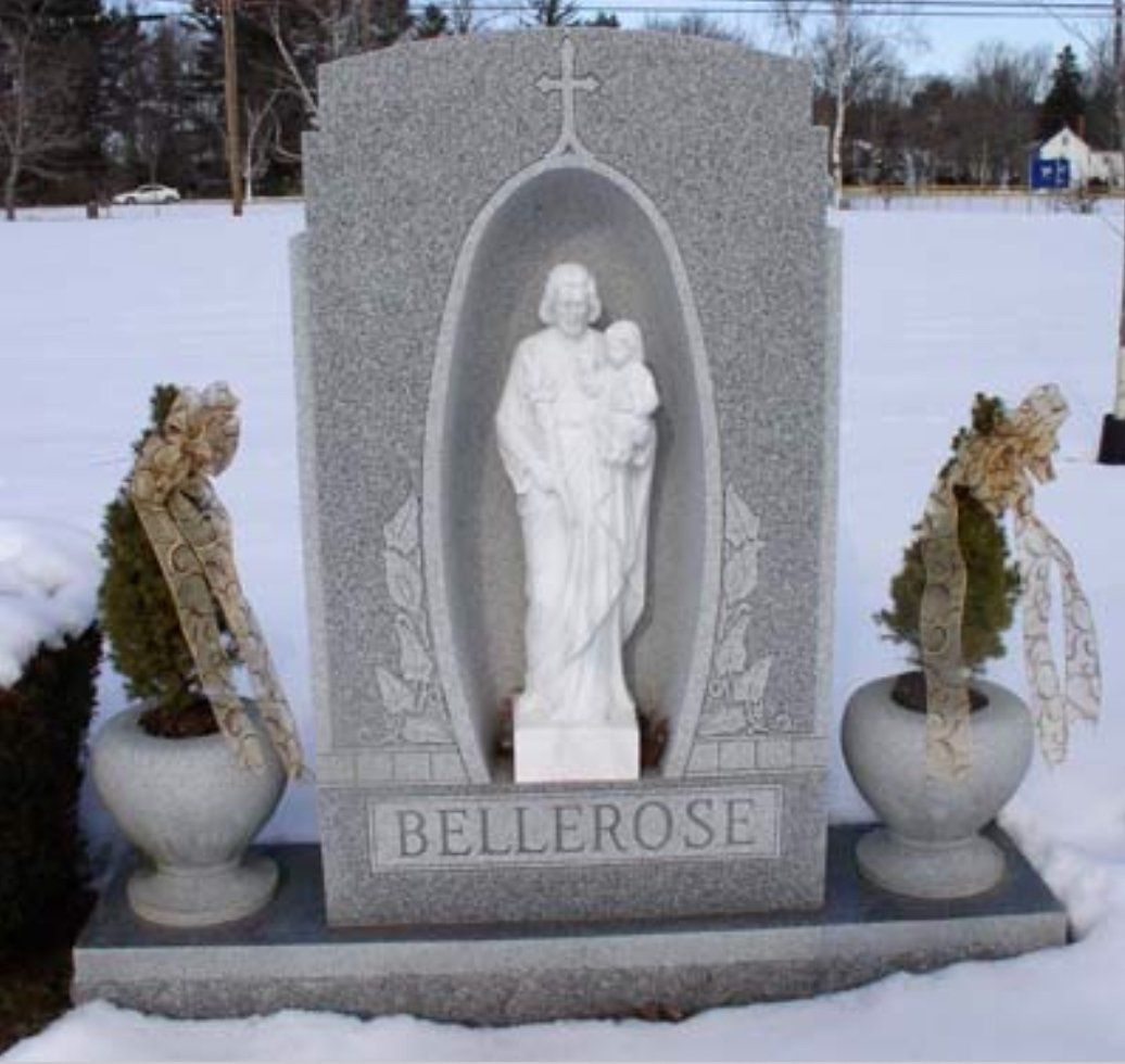 A gravestone for bellerose with a statue of a woman holding a baby