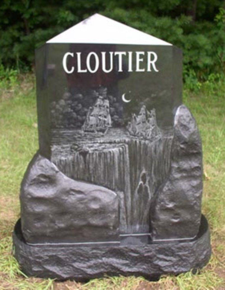 A black gravestone with the name cloutier on it