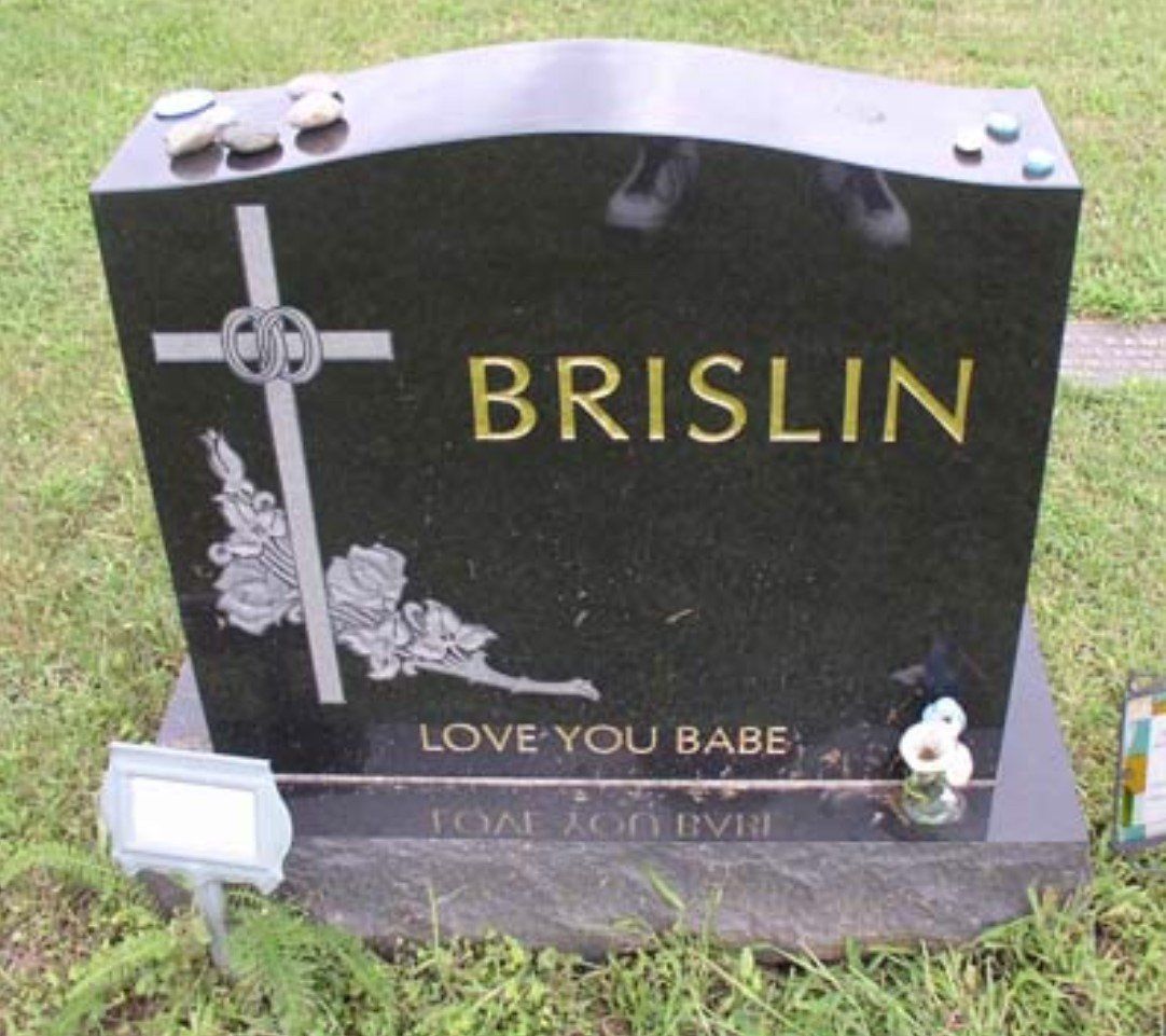 A black gravestone with the name brislin on it