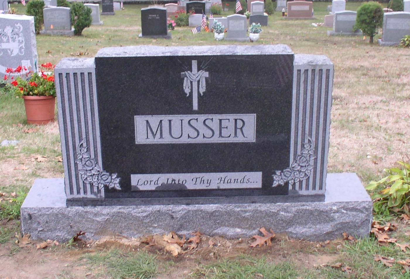 A black gravestone with the name musser on it