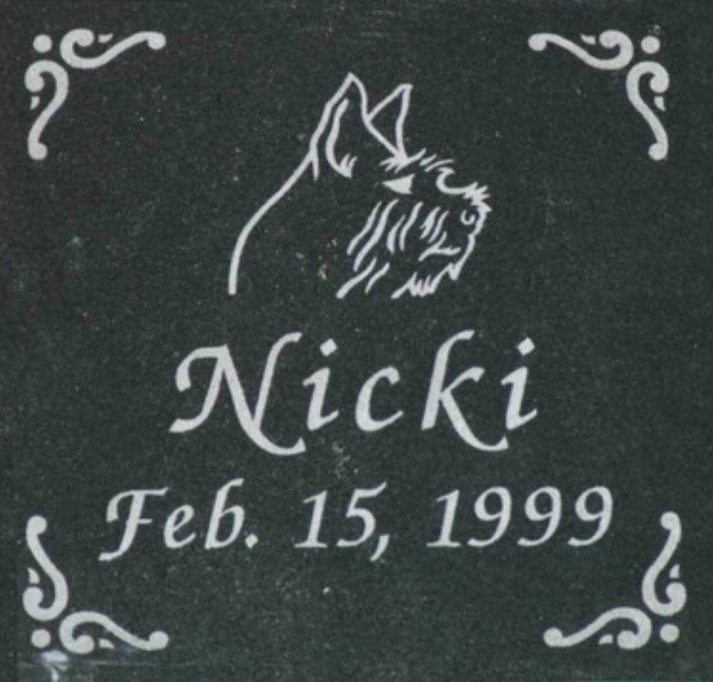 A black plaque with the name nicki and the date february 15 1999