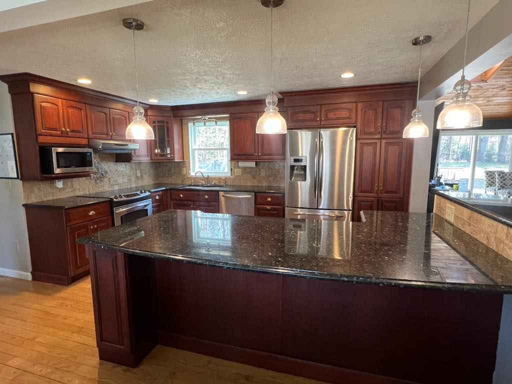 A kitchen with stainless steel appliances and granite counter tops