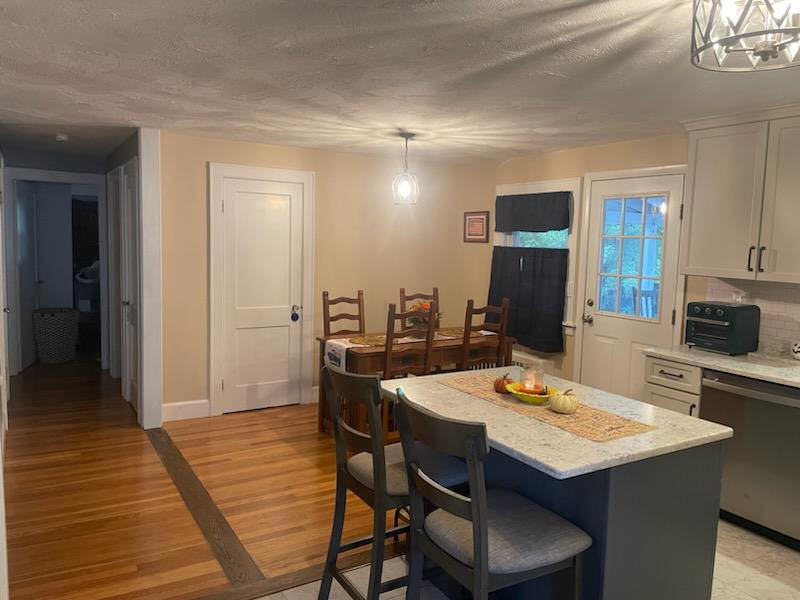 A kitchen with a table and chairs in it.
