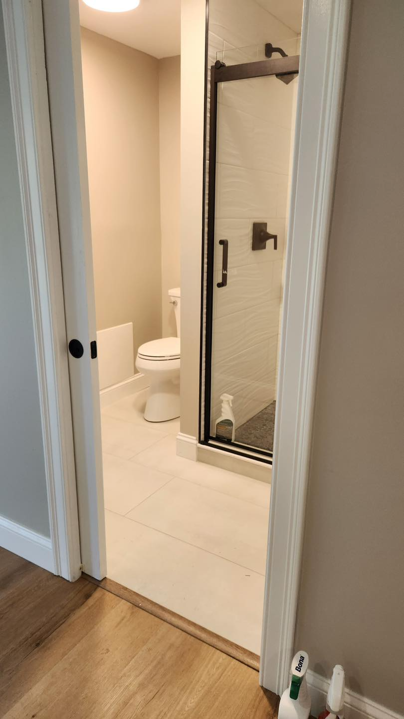 A bathroom with a toilet and a walk in shower.
