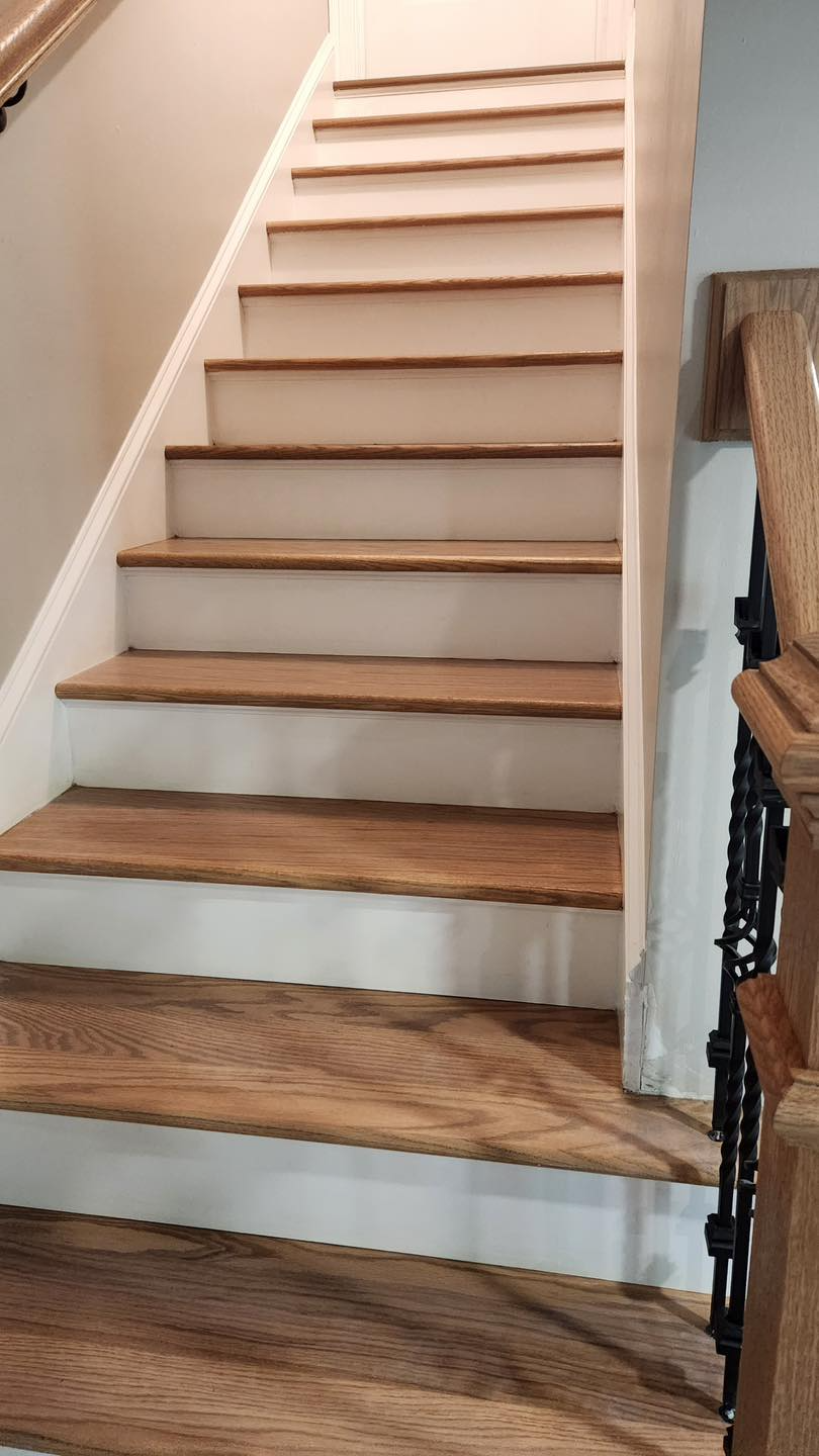 A staircase with wooden steps and white steps in a house.