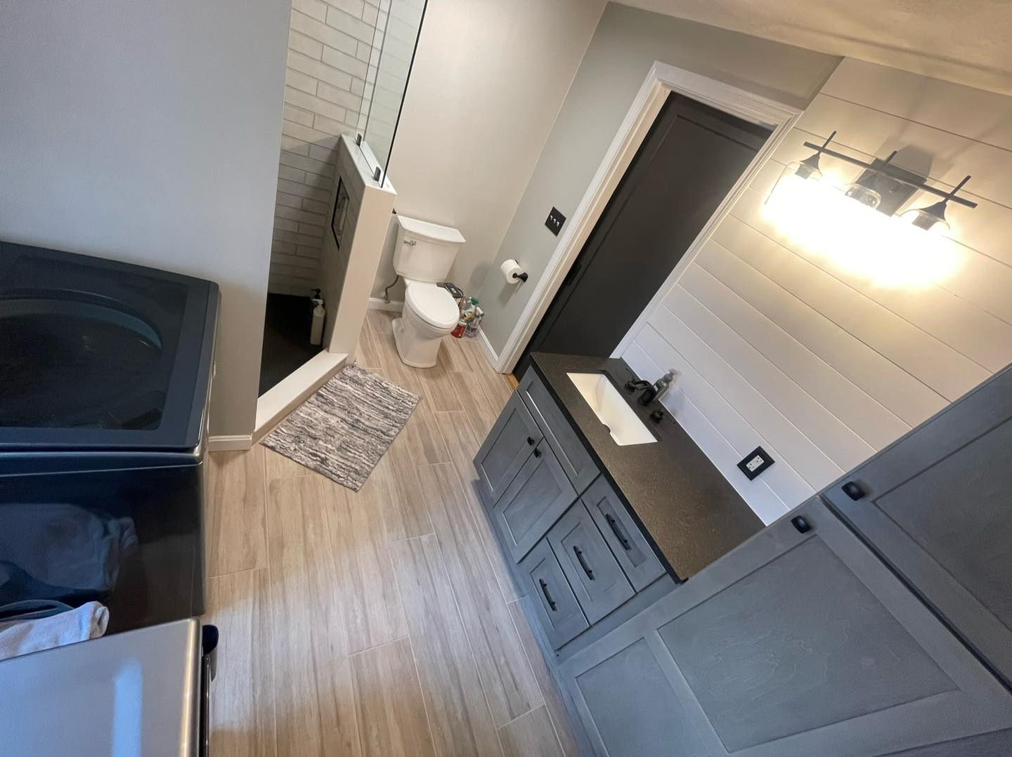 A bathroom with a toilet , sink , and bathtub.