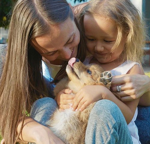 Happy mother and daughter with pet
