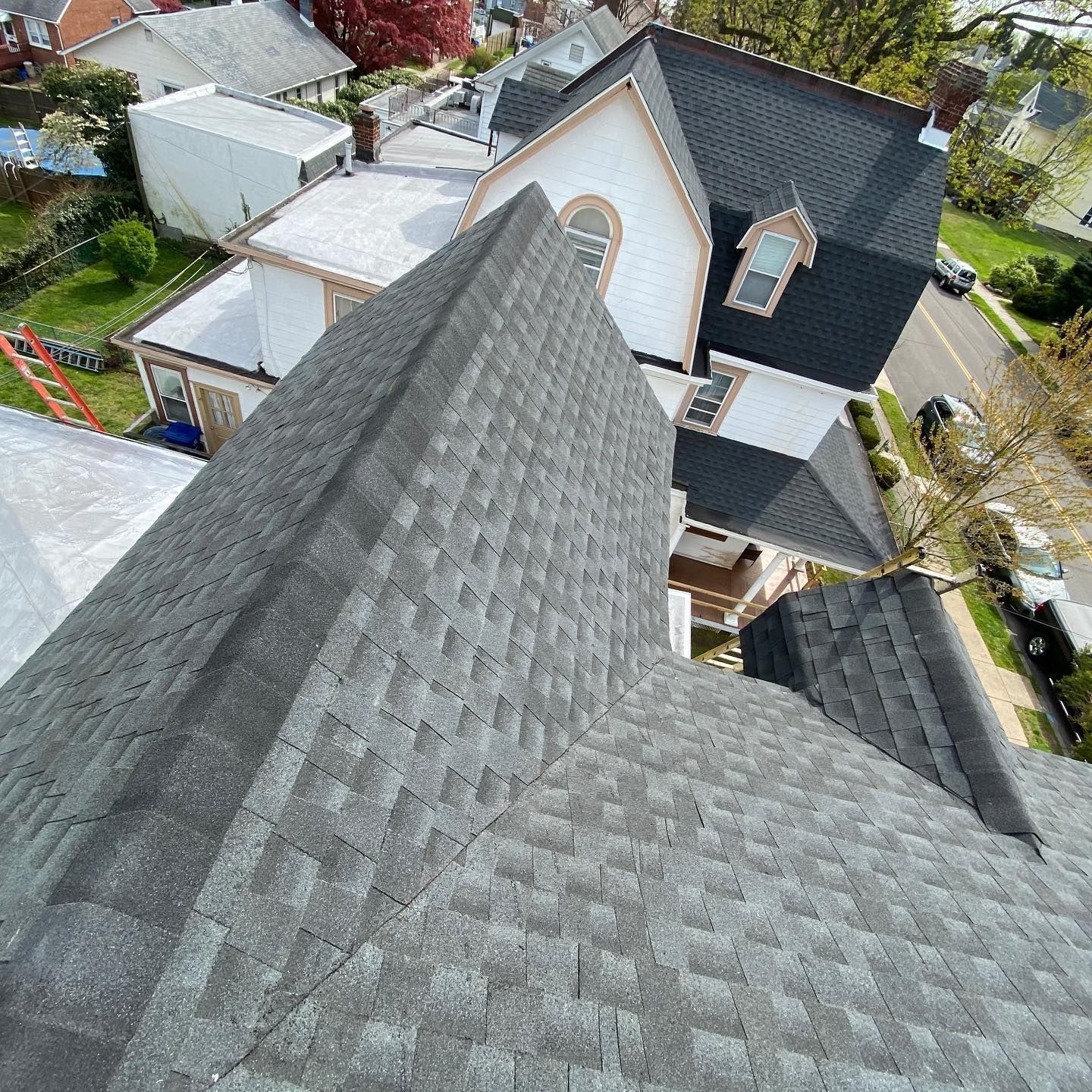 An aerial view of a house with a gray roof