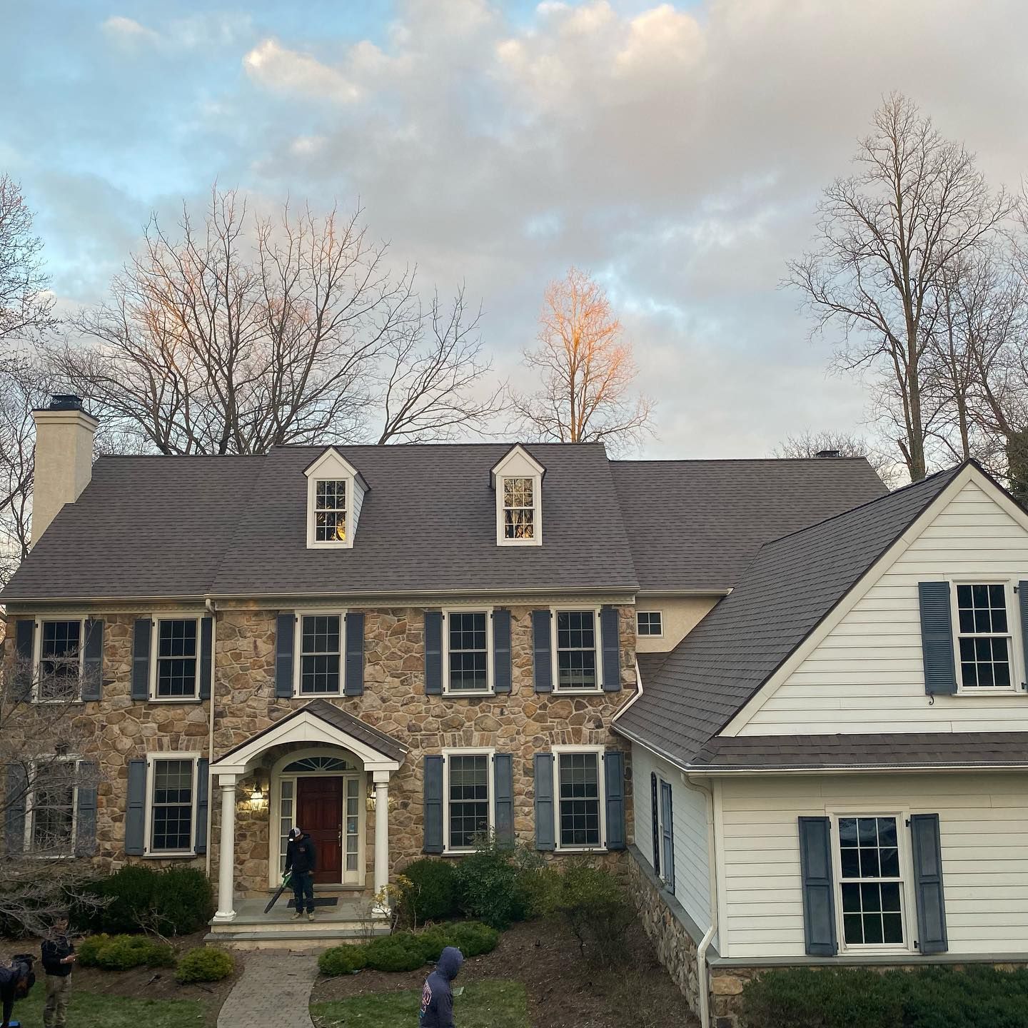 A large stone house with shutters on the windows