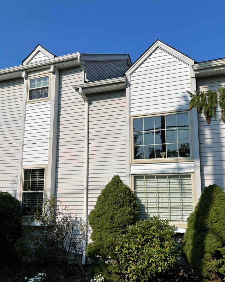 A white house with a blue sky in the background