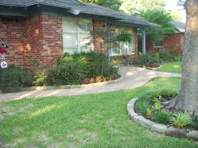 A brick house with a tree in front of it