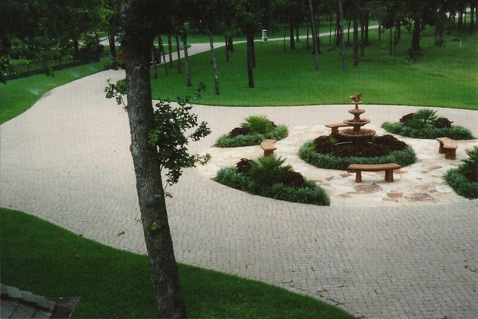 a park with a fountain and benches in the middle