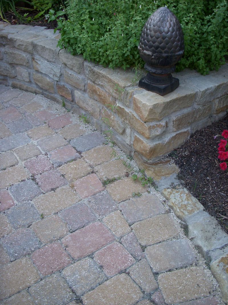 a brick walkway with a statue of an acorn on top of it .