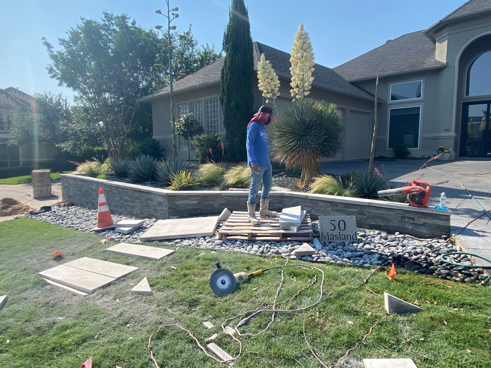 A man is standing in front of a house.