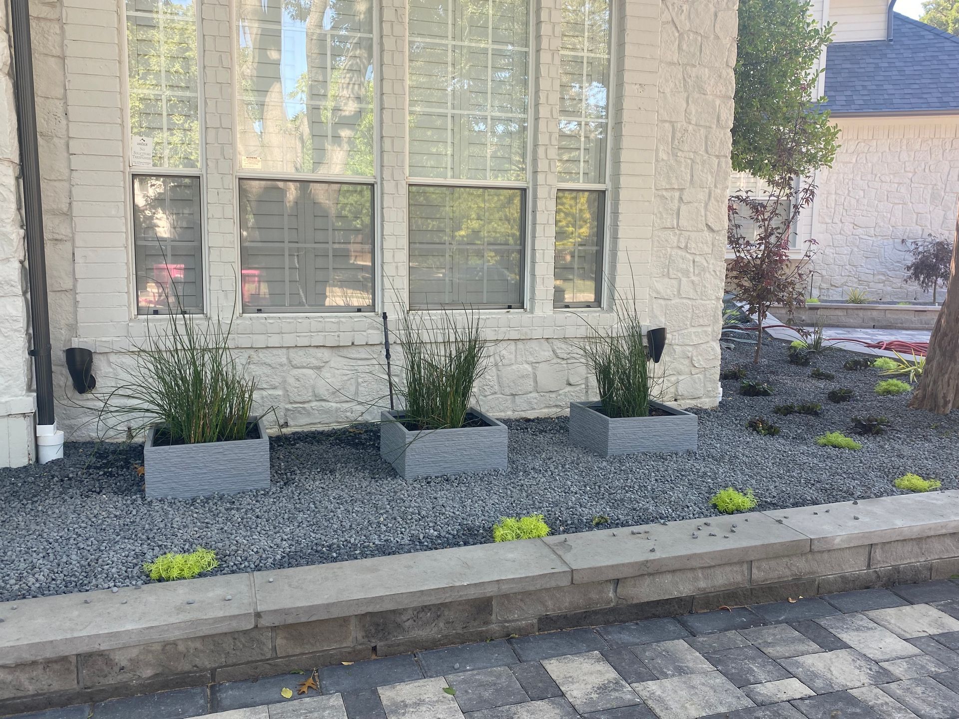 A house with a lot of planters in front of it.