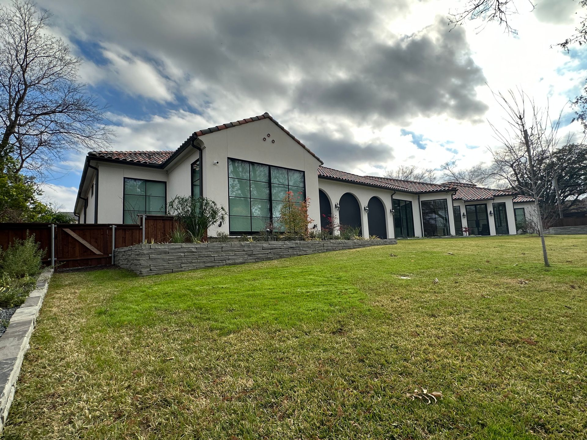 A large white house with a large lawn in front of it.