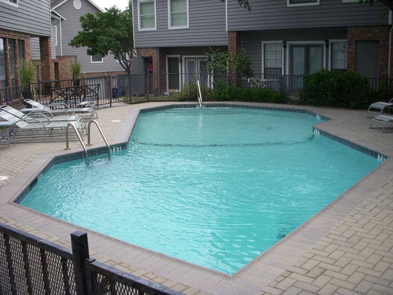a large swimming pool in front of a building