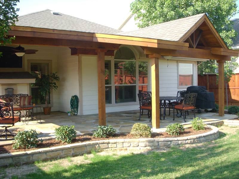 a house with a covered patio with a table and chairs