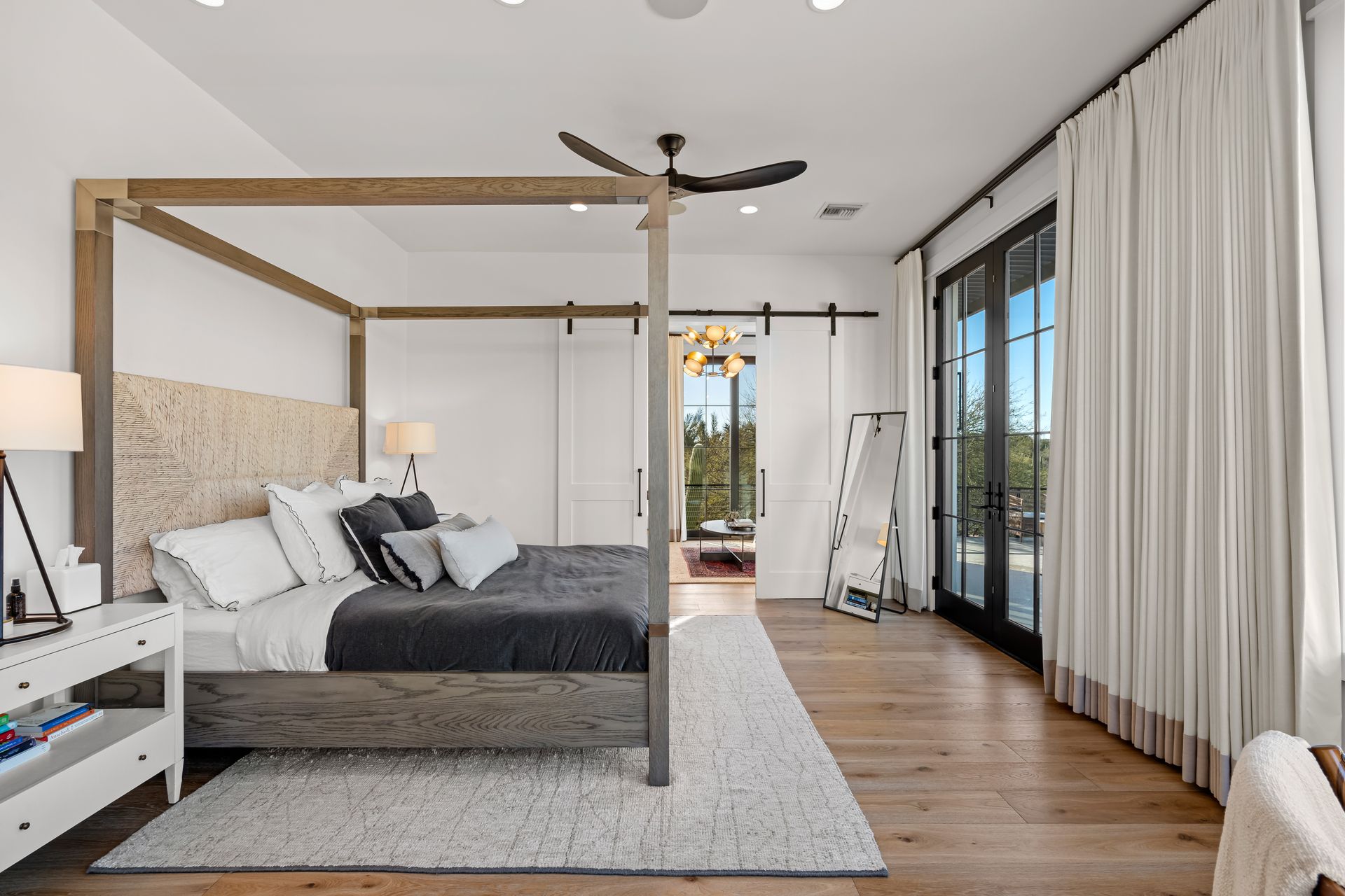 A bedroom with a canopy bed and a ceiling fan.