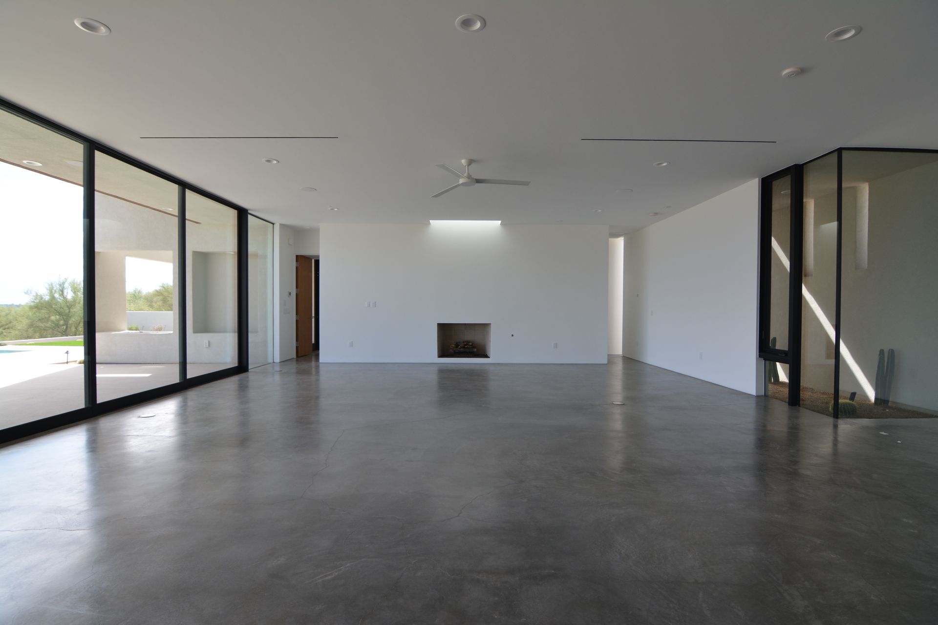 An empty room with a fireplace and a lot of windows