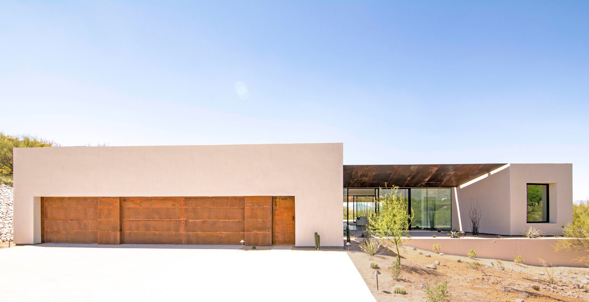 A large white house with a wooden garage door