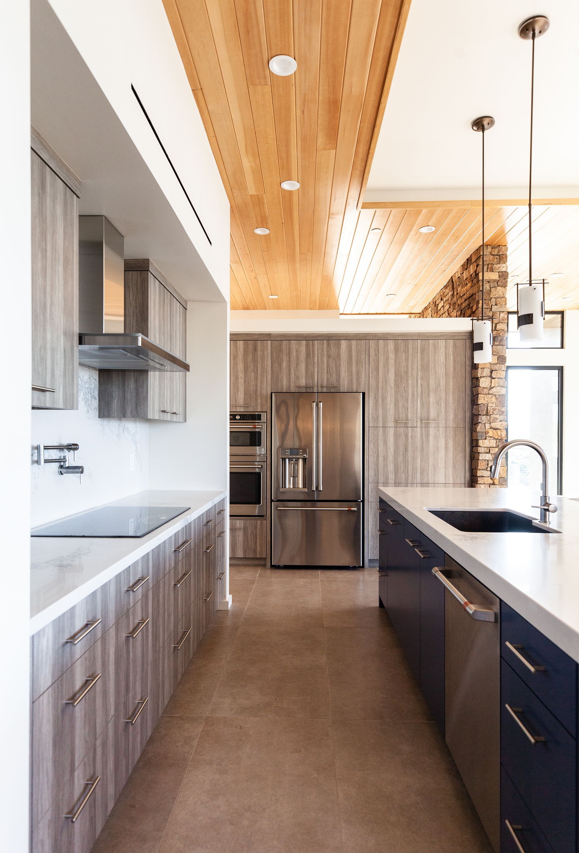 A kitchen with stainless steel appliances and wooden cabinets.