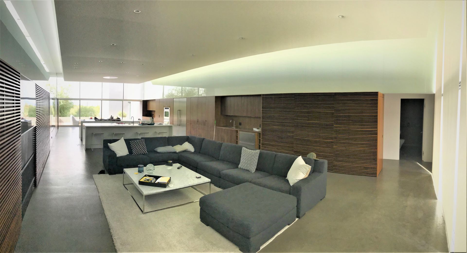A living room with a large sectional couch and a coffee table
